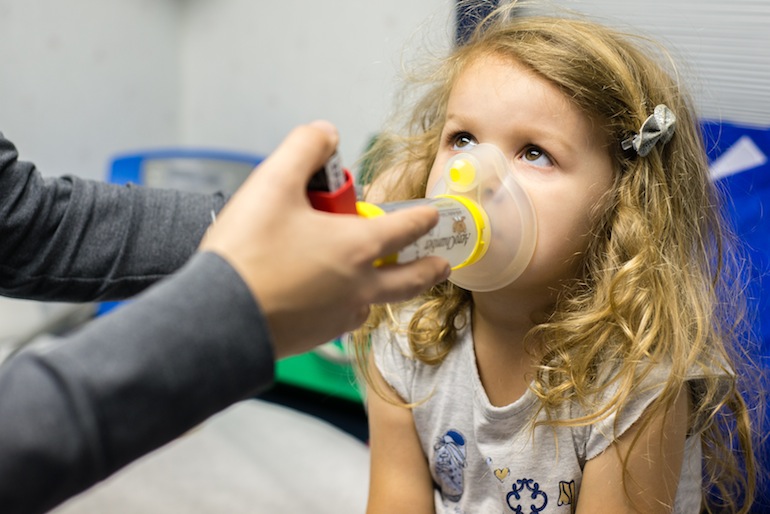 Scarlett Negrete, 3, learns how to use her inhaler during her appointment at the Childrens Hospital of Orange County Breathmobile on April 17, 2015. Negrete has missed 10 days of school this year due to her asthma (Photo by Heidi de Marco/KHN).