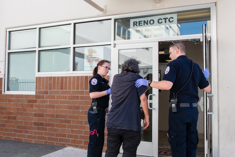 Carter and Hilton help an inebriated patient walk into the Reno Community Triage Center. Before the grant, Carter said the only option for intoxicated patients was the emergency room (Photo by Heidi de Marco/KHN).