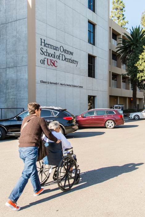 Ada Anderson wheels her mother Violeta Anderson to her dental appointment at the Herman Ostrow School of Dentistry of USC on Friday, November 6, 2015 (Photo by Heidi de Marco/KHN).