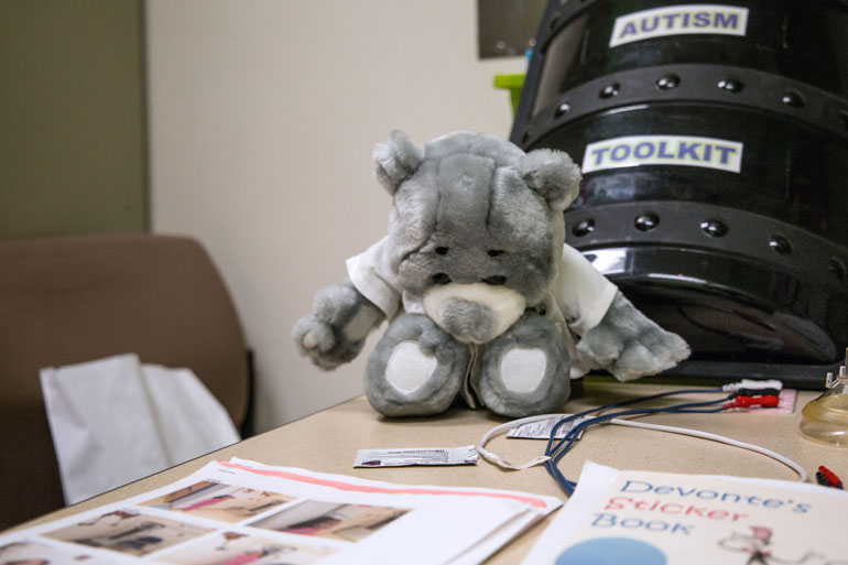 Toys, photo guides and interactive sticker books are some of the tools used at Children’s National to calm patients. For those who struggle with verbal communication, these can offer other ways of understanding what they’re about to undergo. (Francis Ying/KHN)
