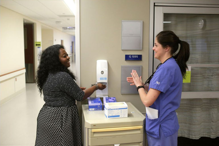 Andrea Stone, left, and Kaleigh Nolan at Northwestern Memorial Hospital. “Hand hygiene, as easy as it sounds, that takes a lot,” Ms. Stone said. (Joshua Lott for The New York Times)