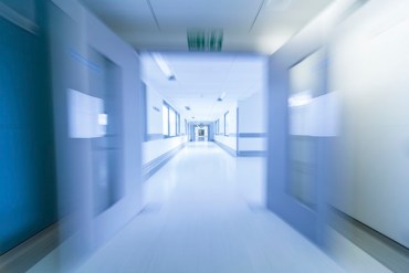 A motion blurred photograph of an empty hospital corridor