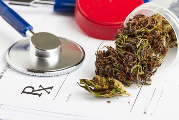 Medical marijuana in jar lying on prescription form near stethoscope. Cannabis recipe for personal use. Legal drugs concept