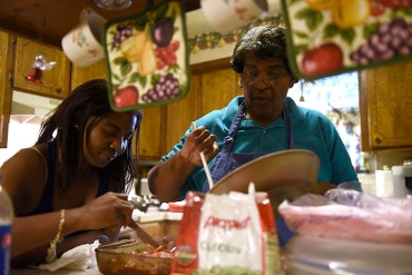 Sharissa Derricott helps her mother Cheryl prepare dinner at her parents’ home in Lawton Oklahoma. Derricott says she took Lupron from age 5 to 12 to shut down early puberty. At 30, she’s among the first patients who took the drug – even before it was approved for pediatric use. (Nick Oxford/for KHN)