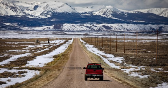 landscape of Walden, Colorado with a red truck on a rural road