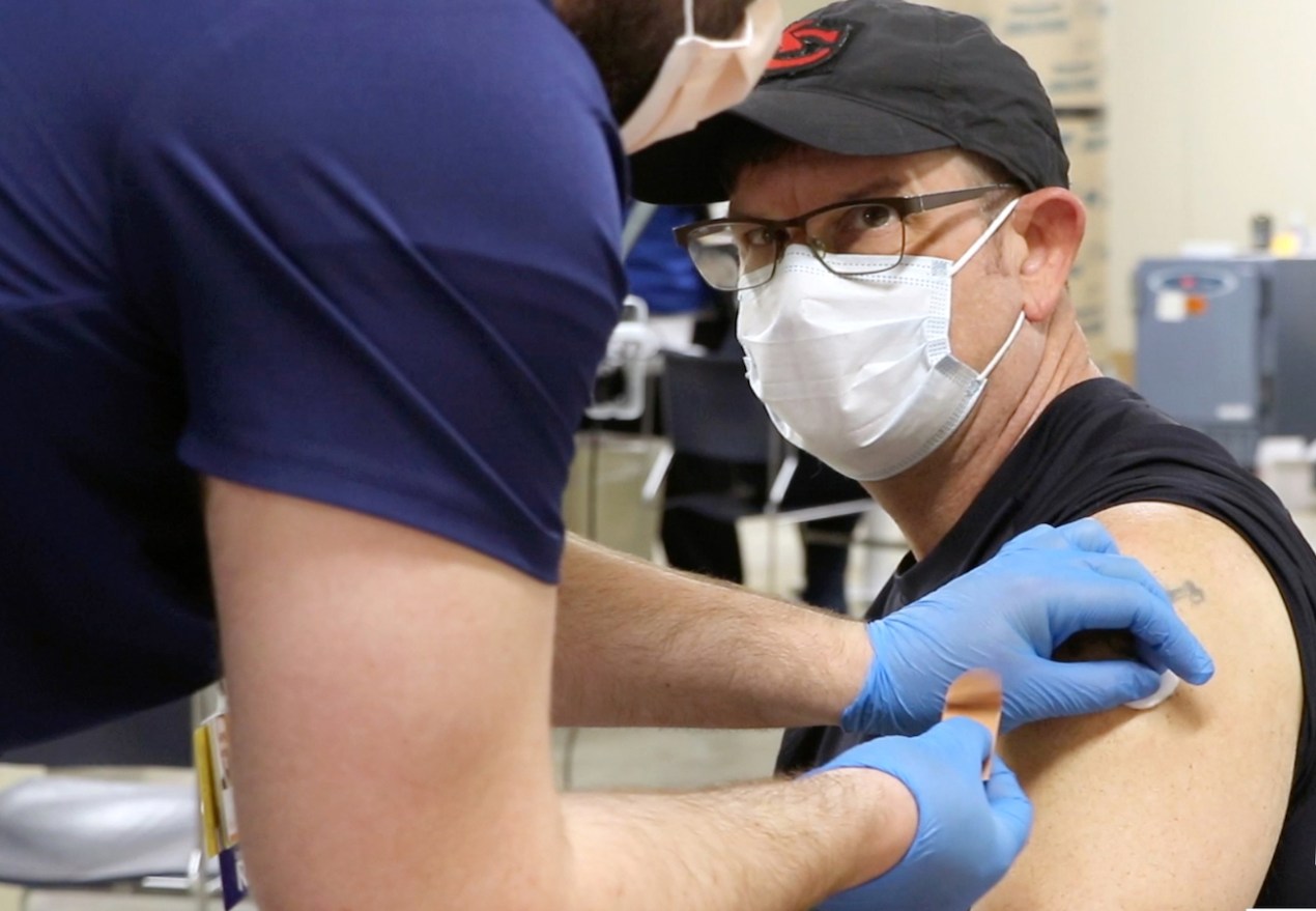 A man receives a COVID-19 vaccine