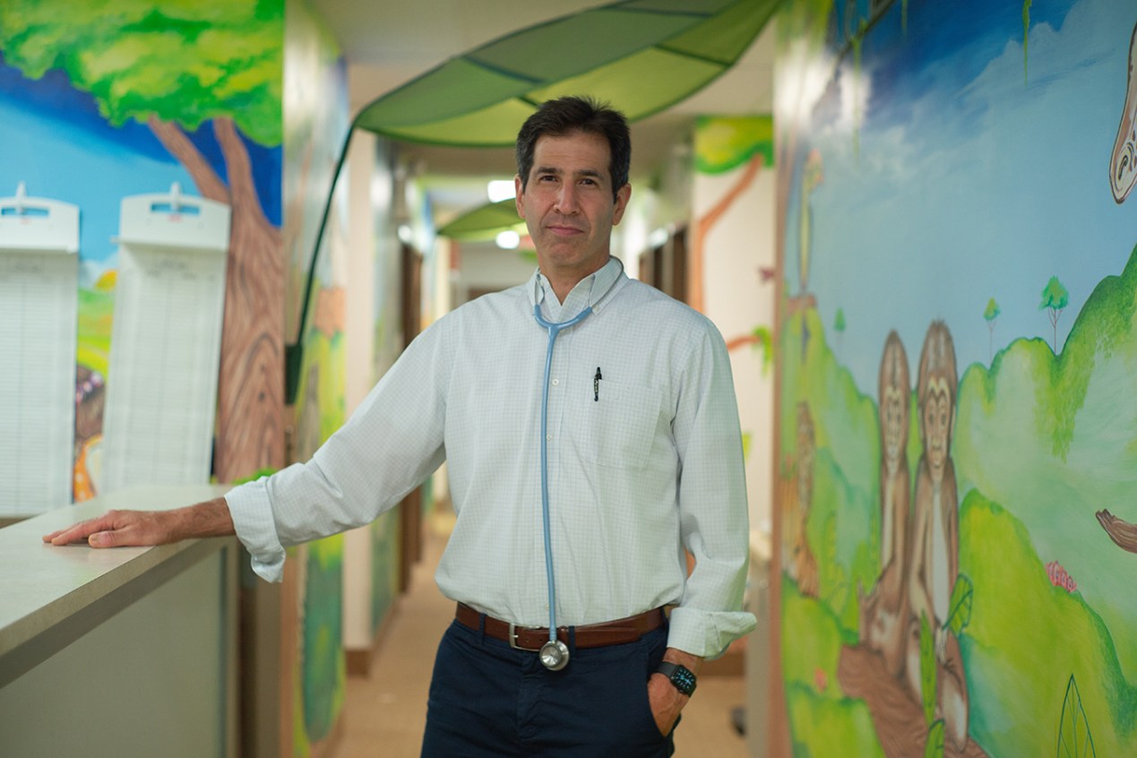 portrait of Dr. Eric Berger standing in his pediatric practice