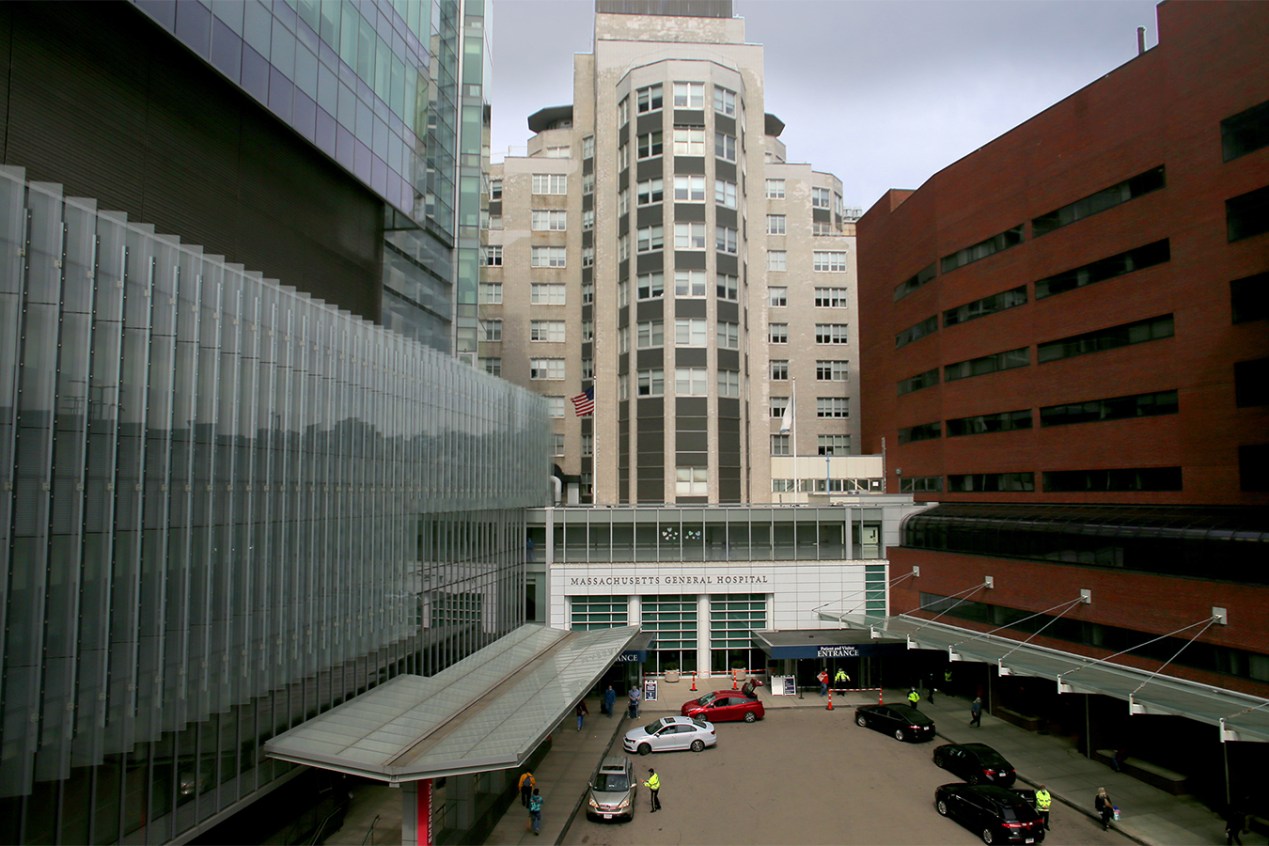 Cars are parked in front of the Massachusetts General Hospital entrance.
