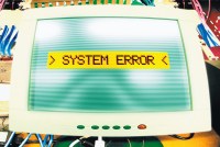 computer screen with error message in yellow reading "system error"