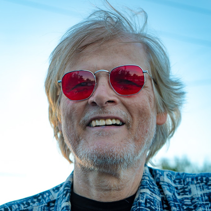 Terry Bell is seen smiling for a photo and wearing sunglasses.