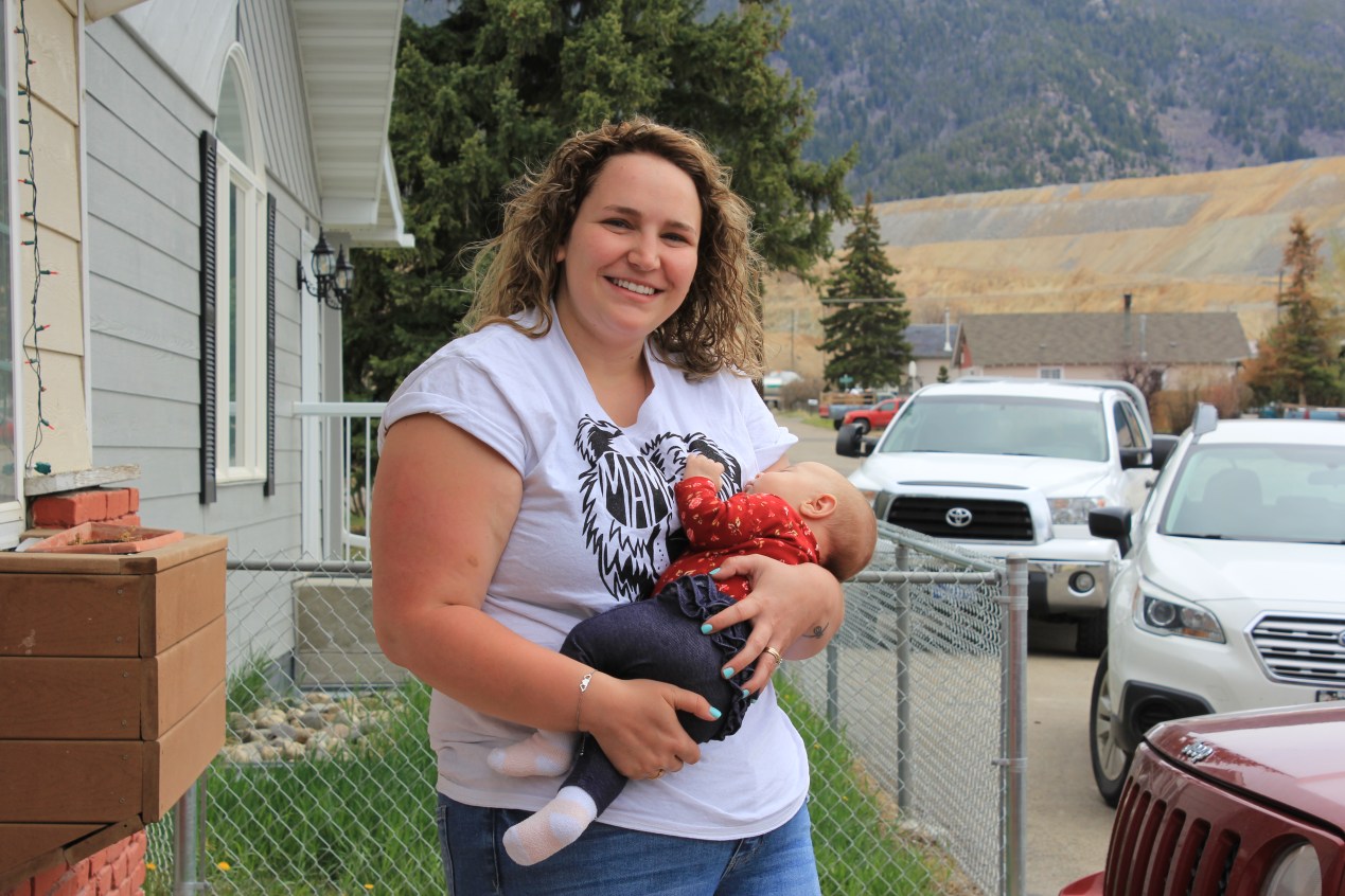 Haley Rehm holds her 2-month-old baby just outside of her home just across the street from the Continental mine in Butte, Montana.