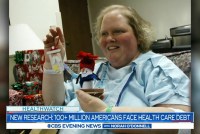 A screenshot of a newscast shows a photo of a woman in a hospital gown. Text on the screen reads, "New research: 100+ million Americans face health care debt."