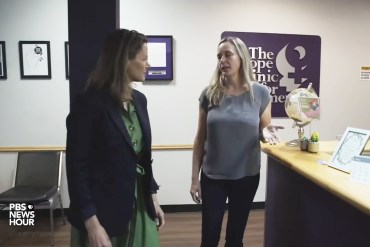 A still from a video shows reporter Sarah Varney speaking with a source inside of a clinic.