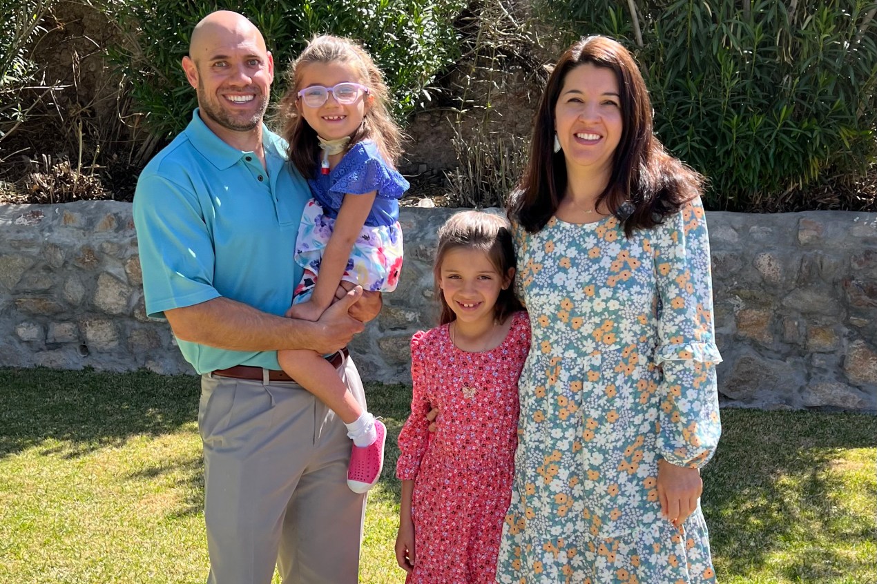 A family photo shows Jacob Boggs holding his daughter Emma and standing next to his daughter Riley and his wife Courtney Boggs.