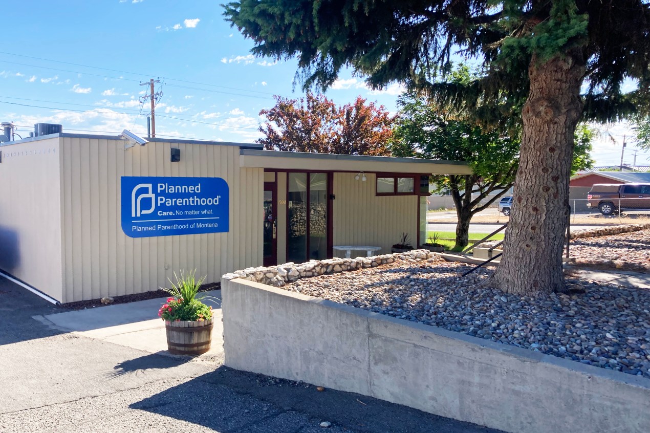 A photo shows the exterior of a Planned Parenthood clinic. A sign on the building reads, "Care no matter what."