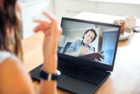 A photo shows a client speaking to an online counselor via video call on a laptop.
