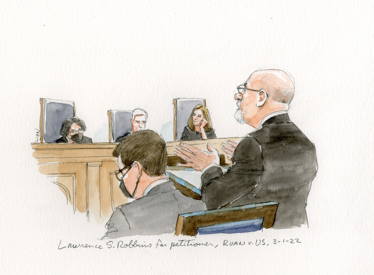 A traditional courtroom illustration, in watercolor and pencil, depicting attorney Lawrence Robbins arguing before the Supreme Court. He wears a black suit, glasses, and is bald.