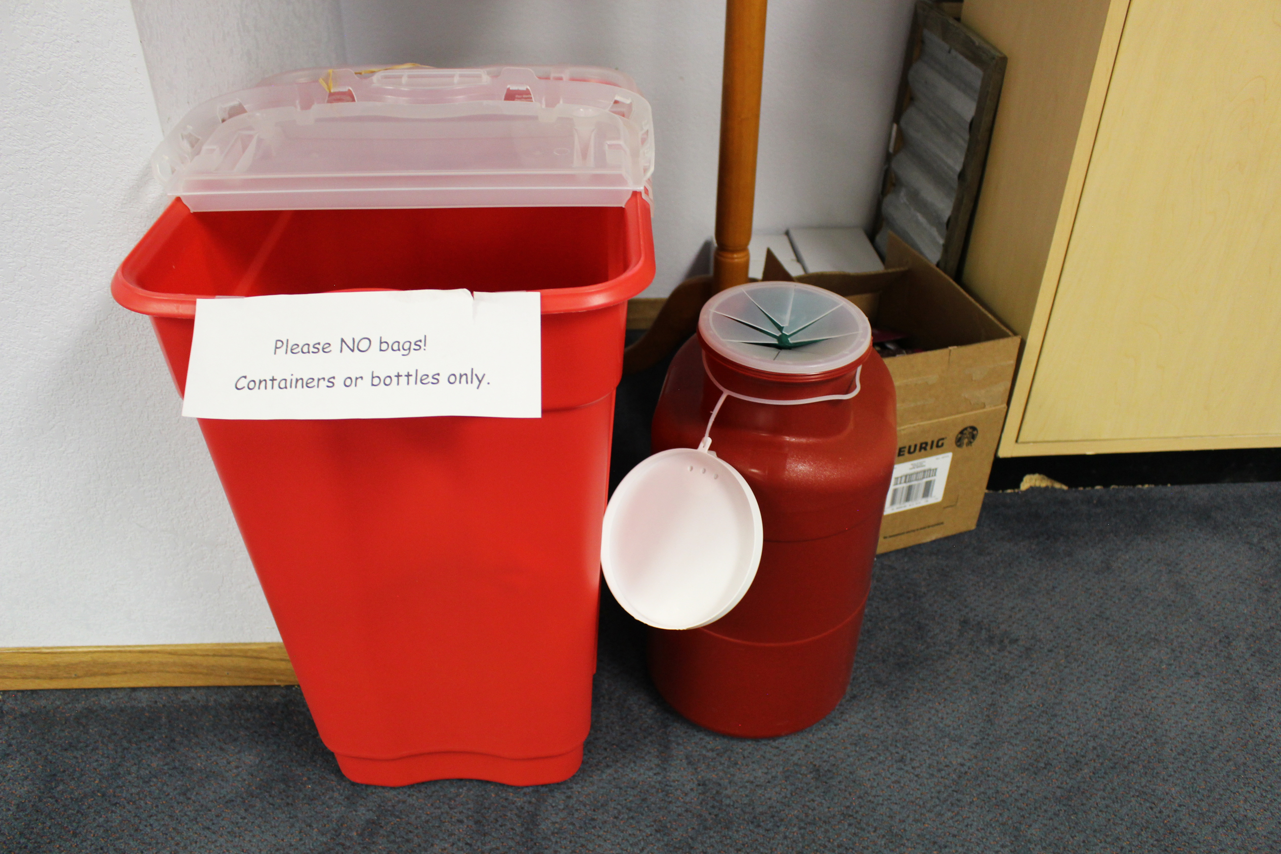 A photo shows a needle disposal box and a wastebin. The wastebin, on the left, has a sign that reads, "Please NO bags! Containers or bottles only."