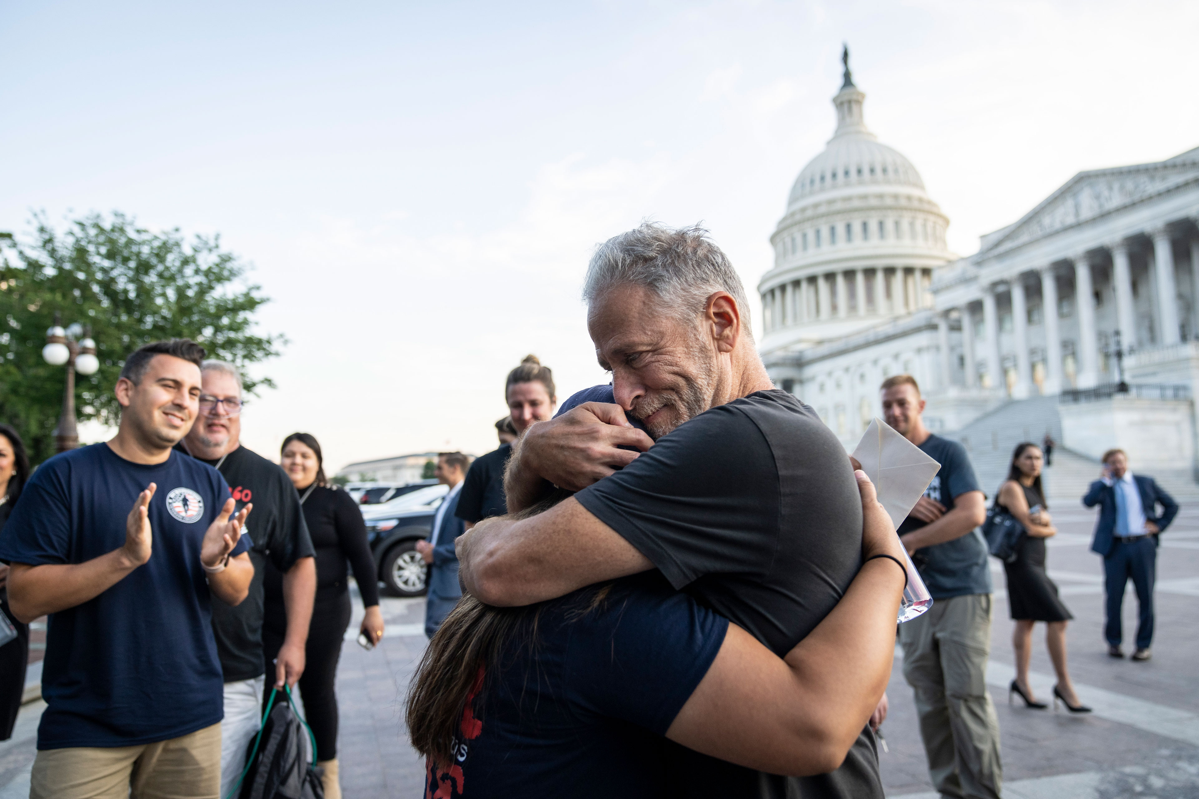 Capitol binasının dışında bir kadın ve bir erkek sarılıyor.