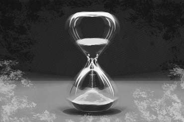 A digital illustration shows a motion-blurred hourglass in stark black and white surrounded by a hand painted border of black and white brush strokes.