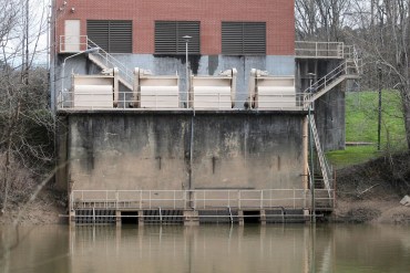 A photo shows a water intake station on the edge of a river.