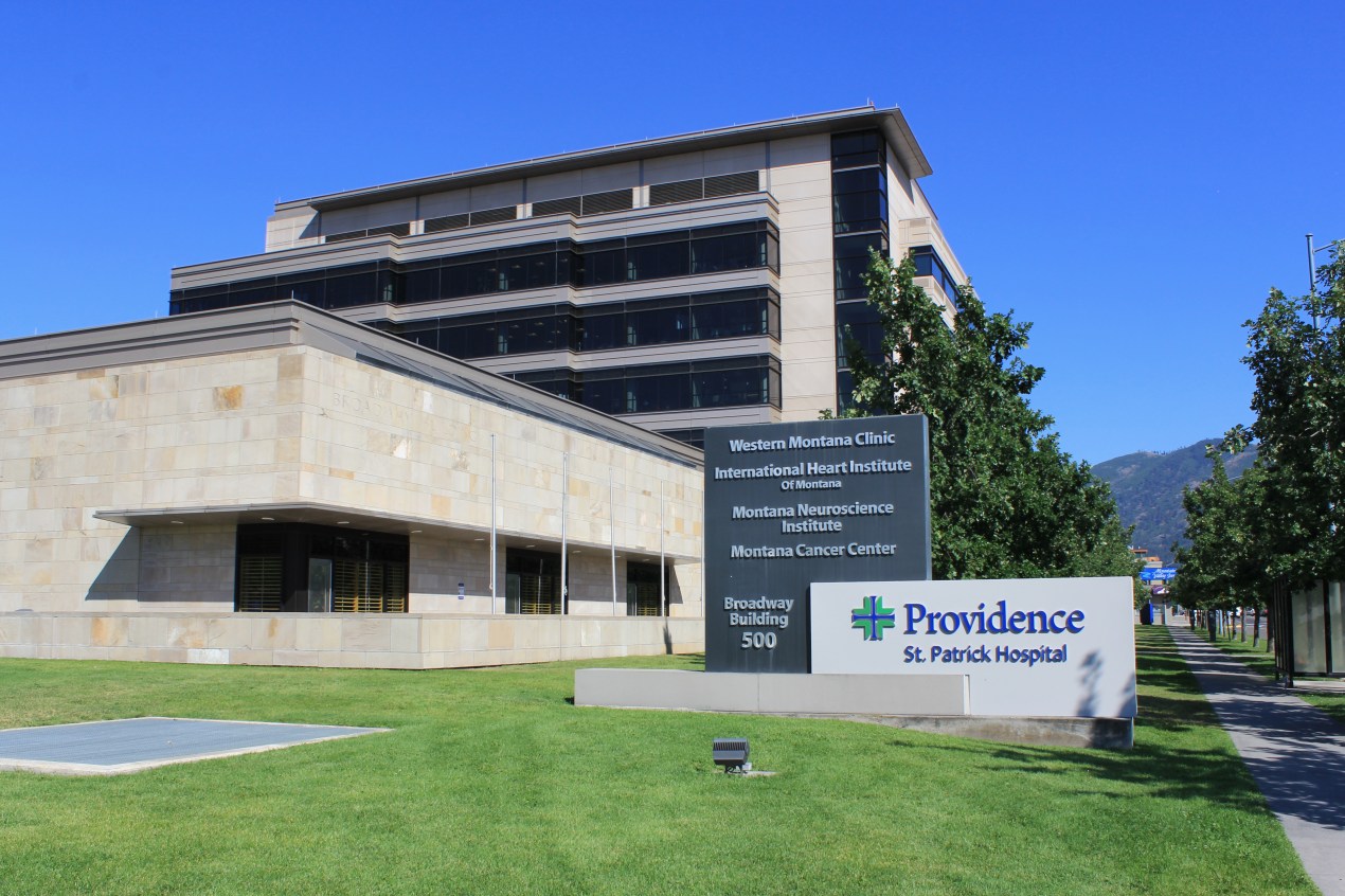 A photo shows the exterior of Providence St. Patrick Hospital. A sign in front of the building bears the hospital's logo and name.
