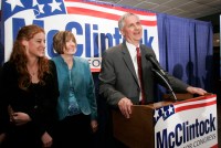A photo shows U.S. Rep. Tom McClintock, his wife, Lori, and daughter, Shannah, at an event. Signs around them read, "McClintock for Congress."