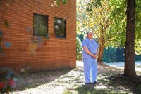 A photo shows Dr. Andrew Bush stasnding outside of his orthopedic practice.