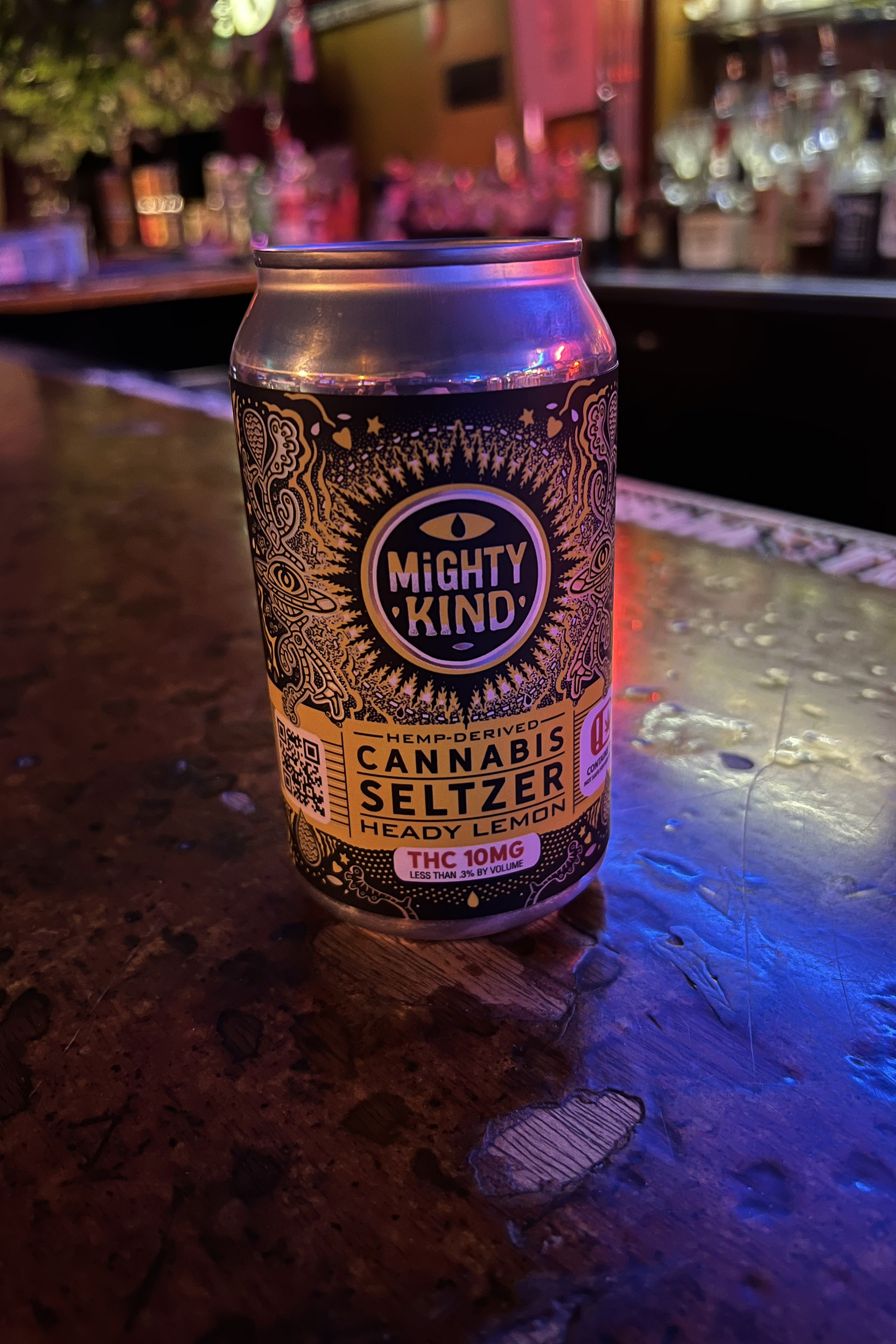 A can of "Mighty Kind Cannabis Seltzer." It has an intricate design and yellow label.