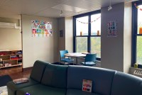 A photo shows the inside of the Mary Hill Youth and Family Center. Colorful signs on the walls read, "You can do it," and "the power of yet."