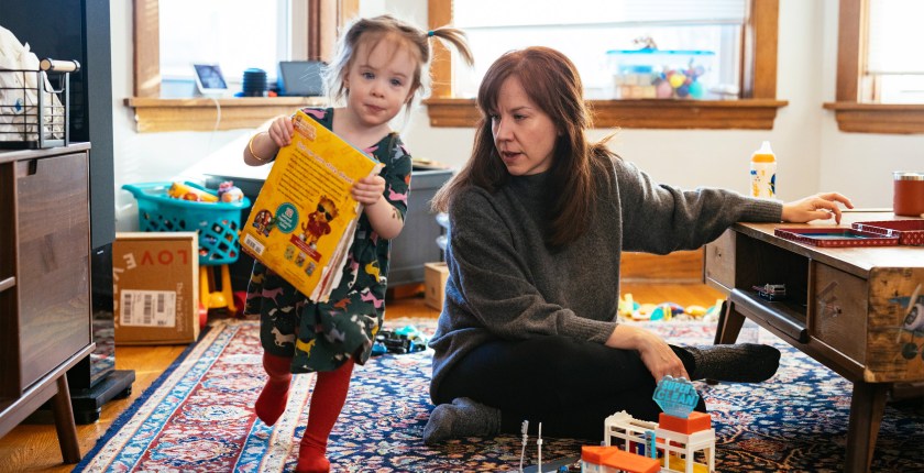 A photo shows Brenna Kearney sitting at home as her daughter, Joey, plays.
